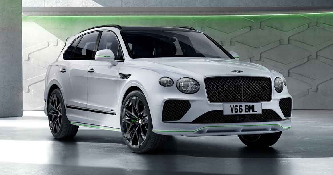 2026 Bentley Bentayga Speed in Glacier White with black accents and green highlights, shown in a modern showroom setting.