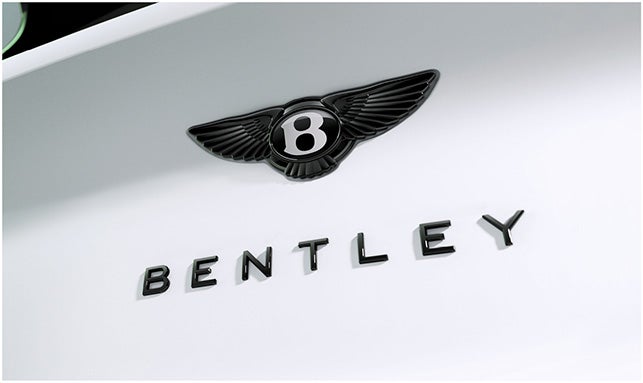 Black Bentley emblem and badge on the rear of the 2026 Bentayga Speed, highlighting sleek rear design and luxury branding.