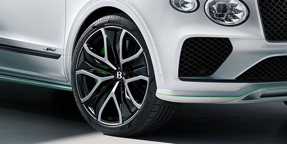 Front wheel and lower fascia of the 2026 Bentley Bentayga Speed featuring gloss black alloy, green caliper, and distinctive Speed badging.
