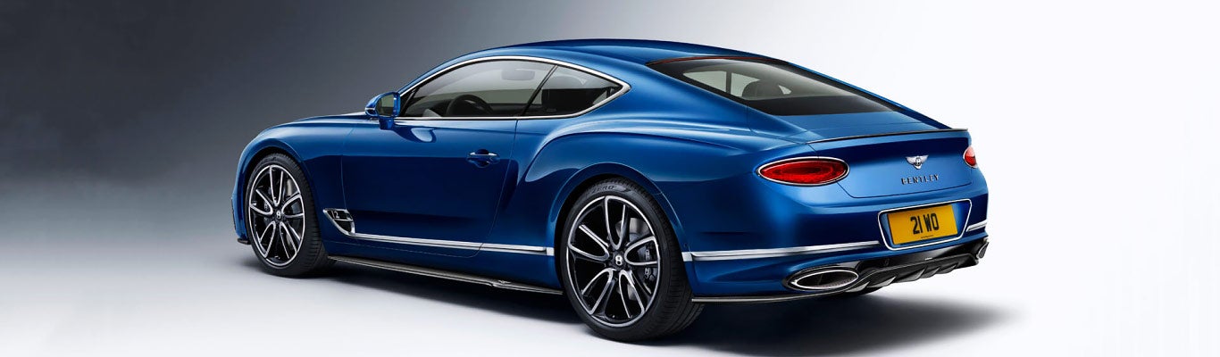 Continental GT rear three quarter in Sequin Blue paint with Carbon Fibre bodykit | Bentley Tampa Bay in Pinellas Park FL